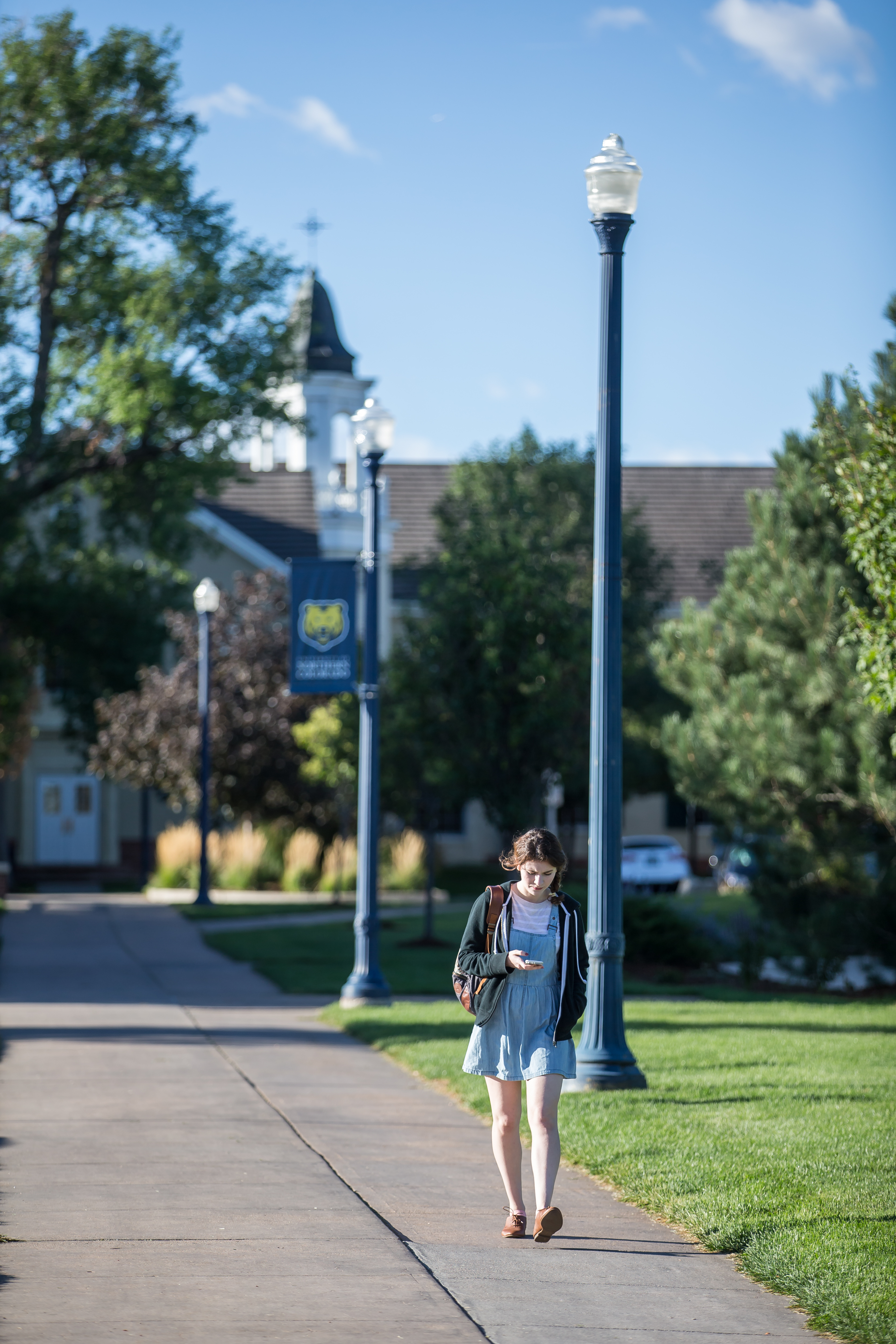 Student walking on UNC campus in the summer.