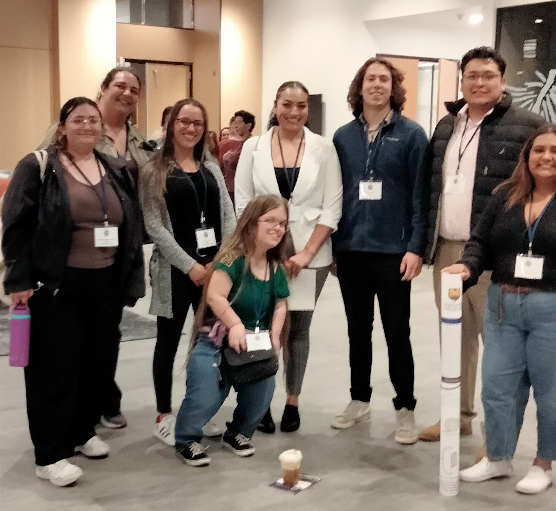 Tyler Engstom and Andrea James stand with their group of fellow researchers.
