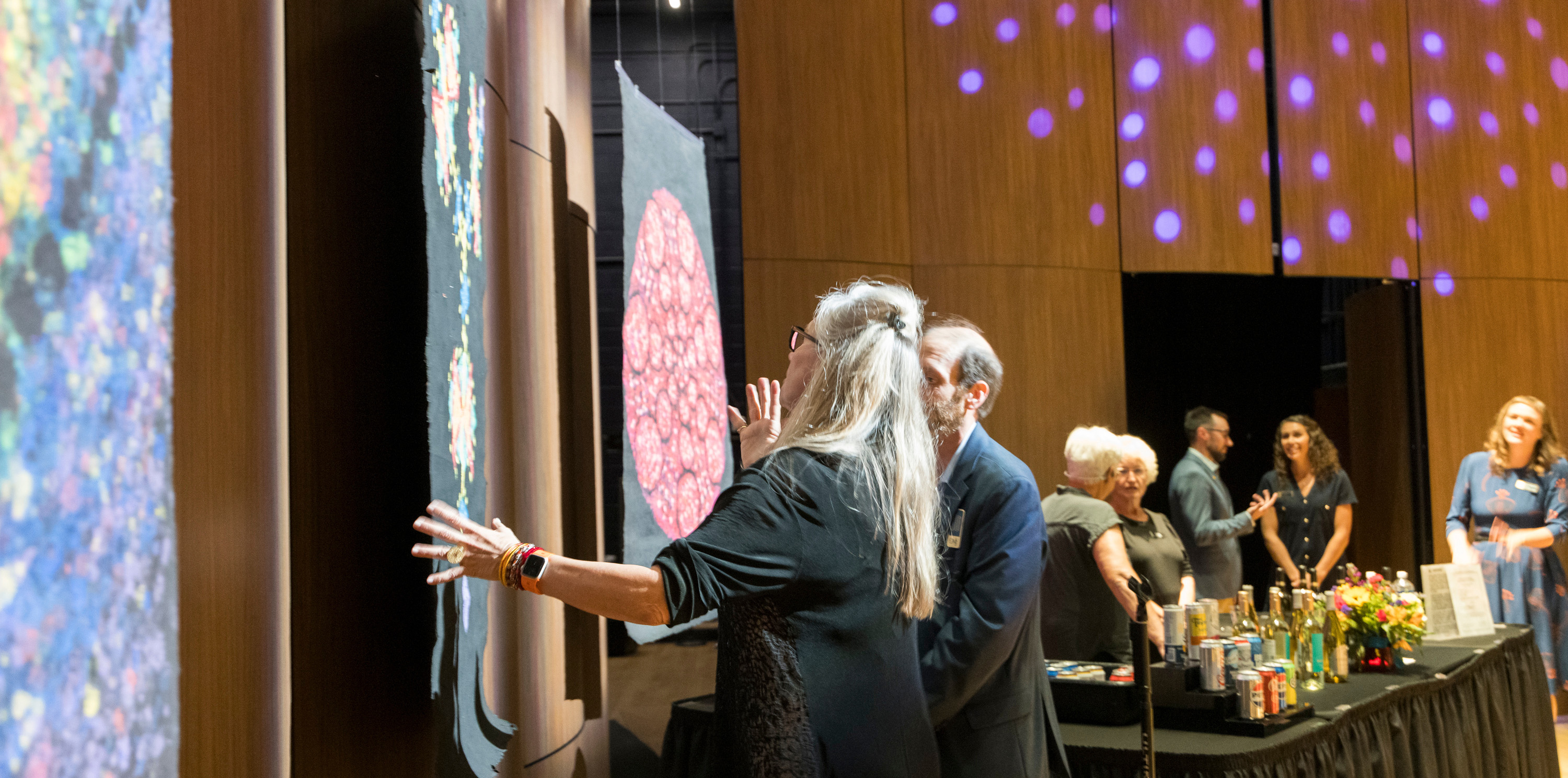 A woman looking at artwork on the wall