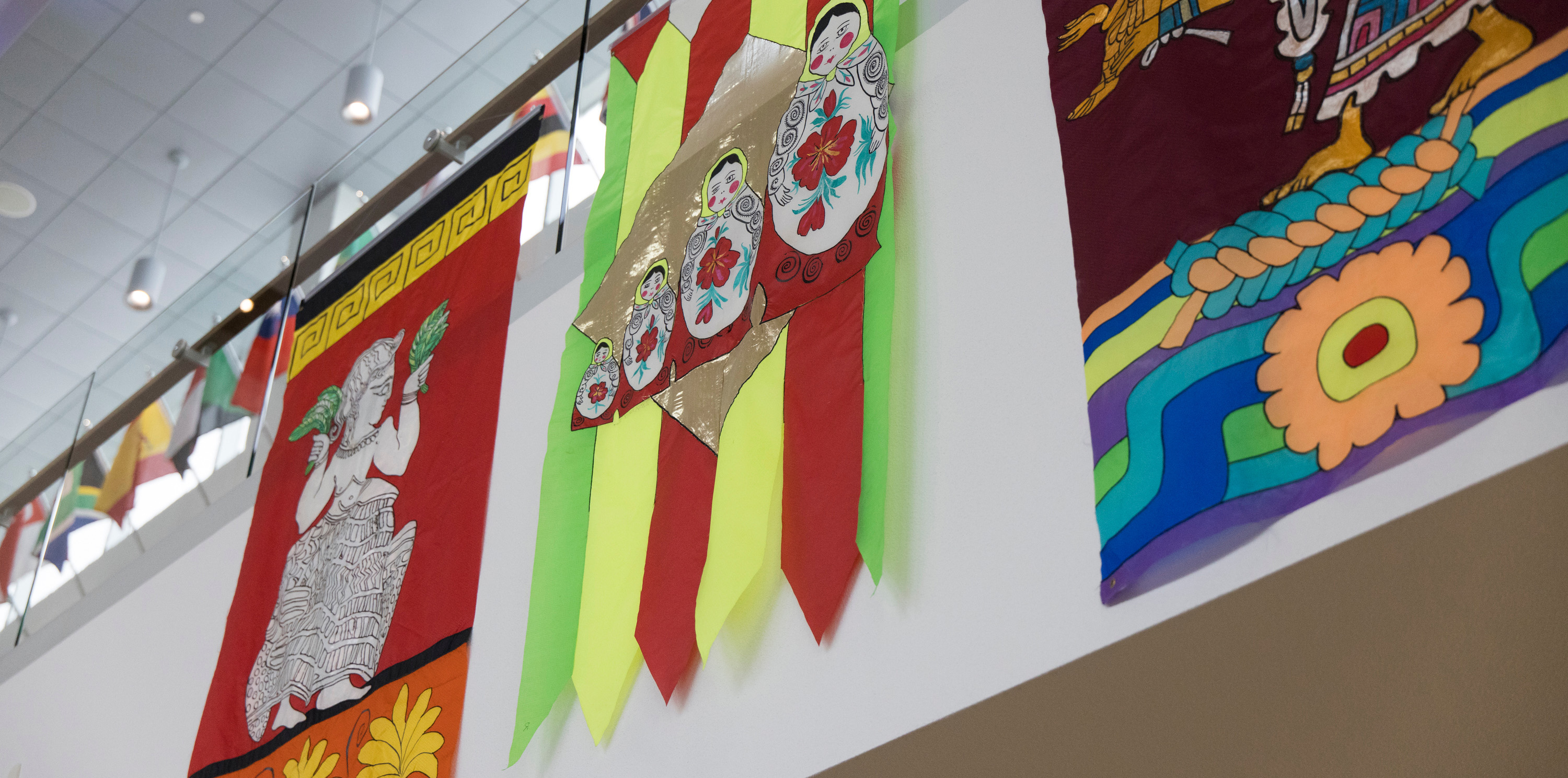 Three flags of Lydia Ruyle's hanging on a wall
