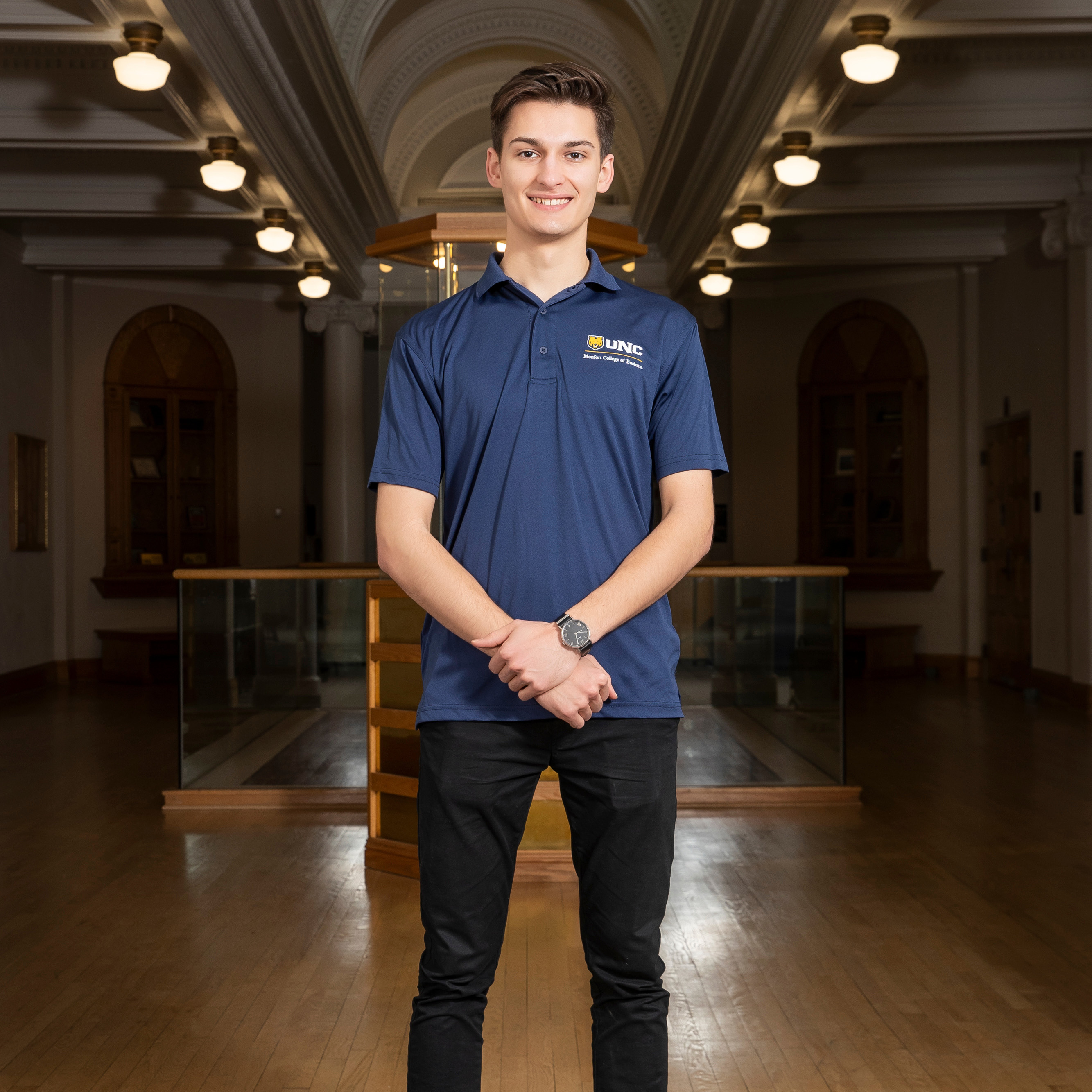 Philip Marshall standing inside with his hands together smiling