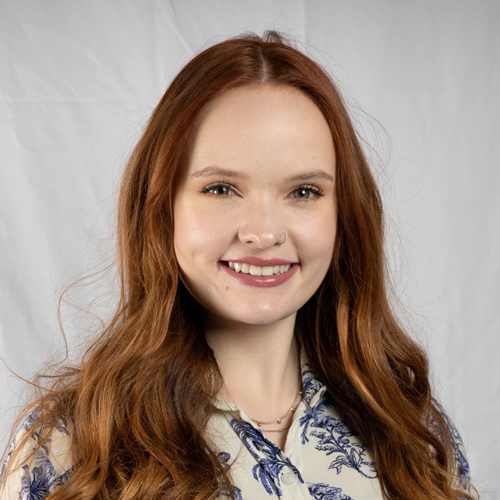 Sarah Pryor facing forward and smiling.