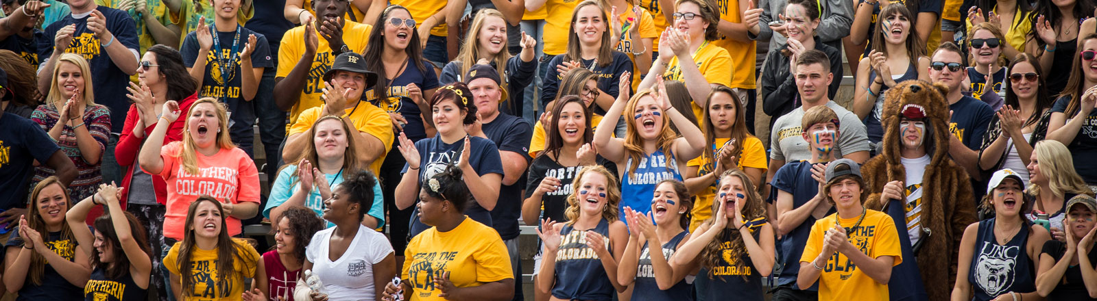 Student cheering at a football game.