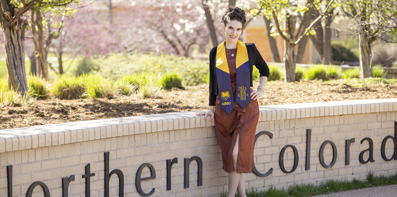 Victoria Rule standing next to a University of Northern Colorado brick sign