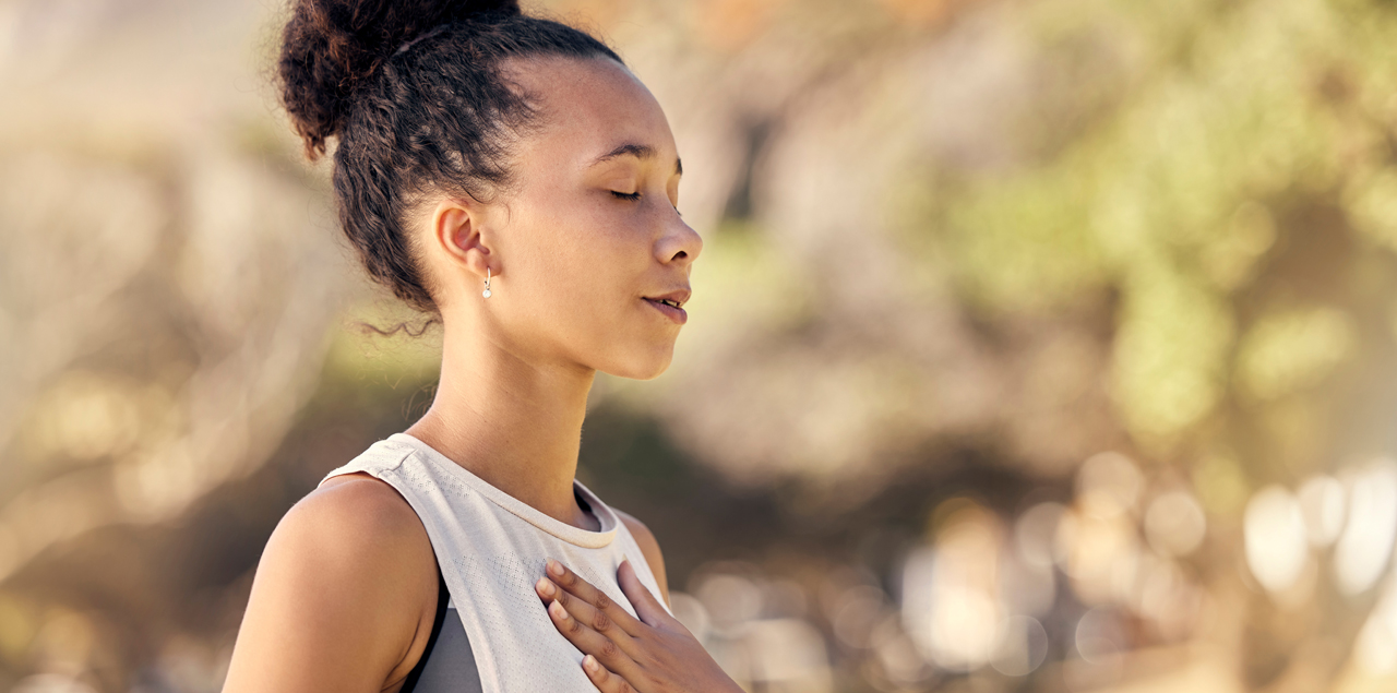 Woman, breathing with hand on chest, being peaceful and relaxed